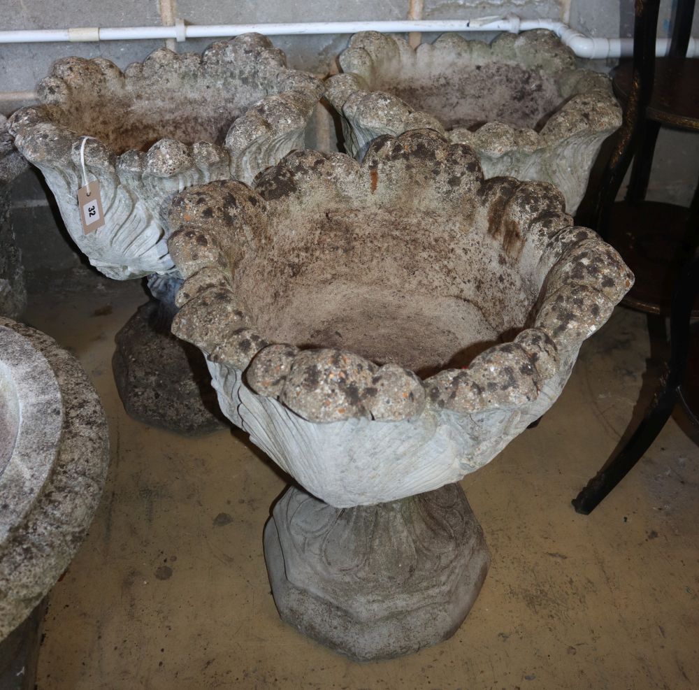 A set of three reconstituted stone campana garden urns, 50cm diameter, H.58cm